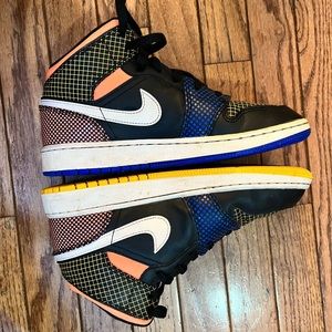 Nike Air Jordan’s: black with white stripe and yellow/orange design.